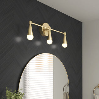 Three Artika Wayden LED mid-century vanity lights above an oval mirror on a dark herringbone tile bathroom wall.