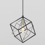 A modern pendant light featuring an exposed bulb surrounded by an open, geometric metal cube frame, suspended from a black cord against a plain light gray background.
