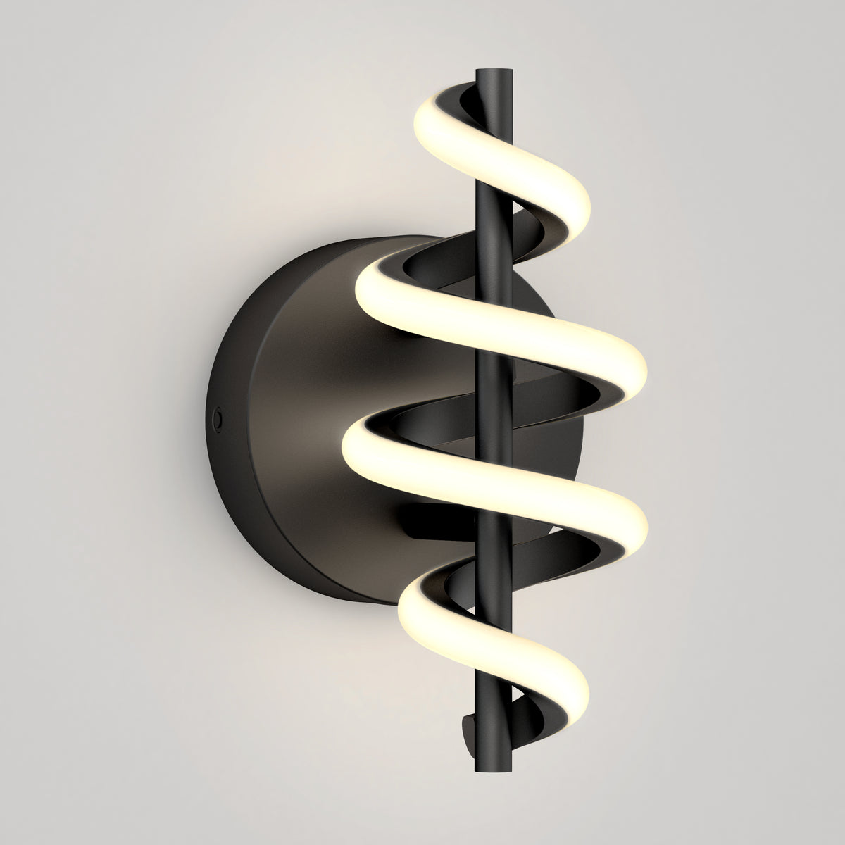 A modern wall sconce with a black circular base and a central rod wrapped by a glowing, spiral LED light, set against a plain light gray background.