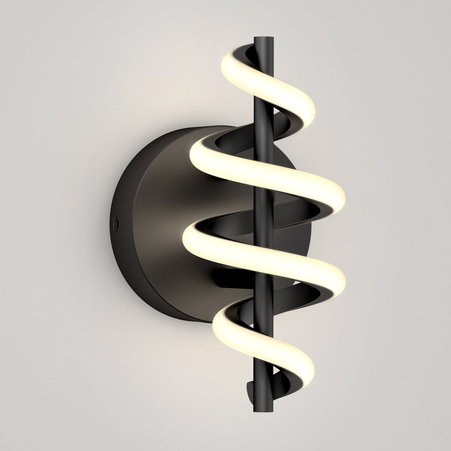 The Artika Chorus LED Wall Light features a black circular base and vertical rod wrapped with a glowing spiral LED, mounted on a light gray wall.