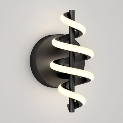 The Artika Chorus LED Wall Light features a black circular base and vertical rod wrapped with a glowing spiral LED, mounted on a light gray wall.