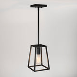 A modern black pendant light with a geometric metal frame and an exposed bulb hangs from a ceiling against a plain white background.