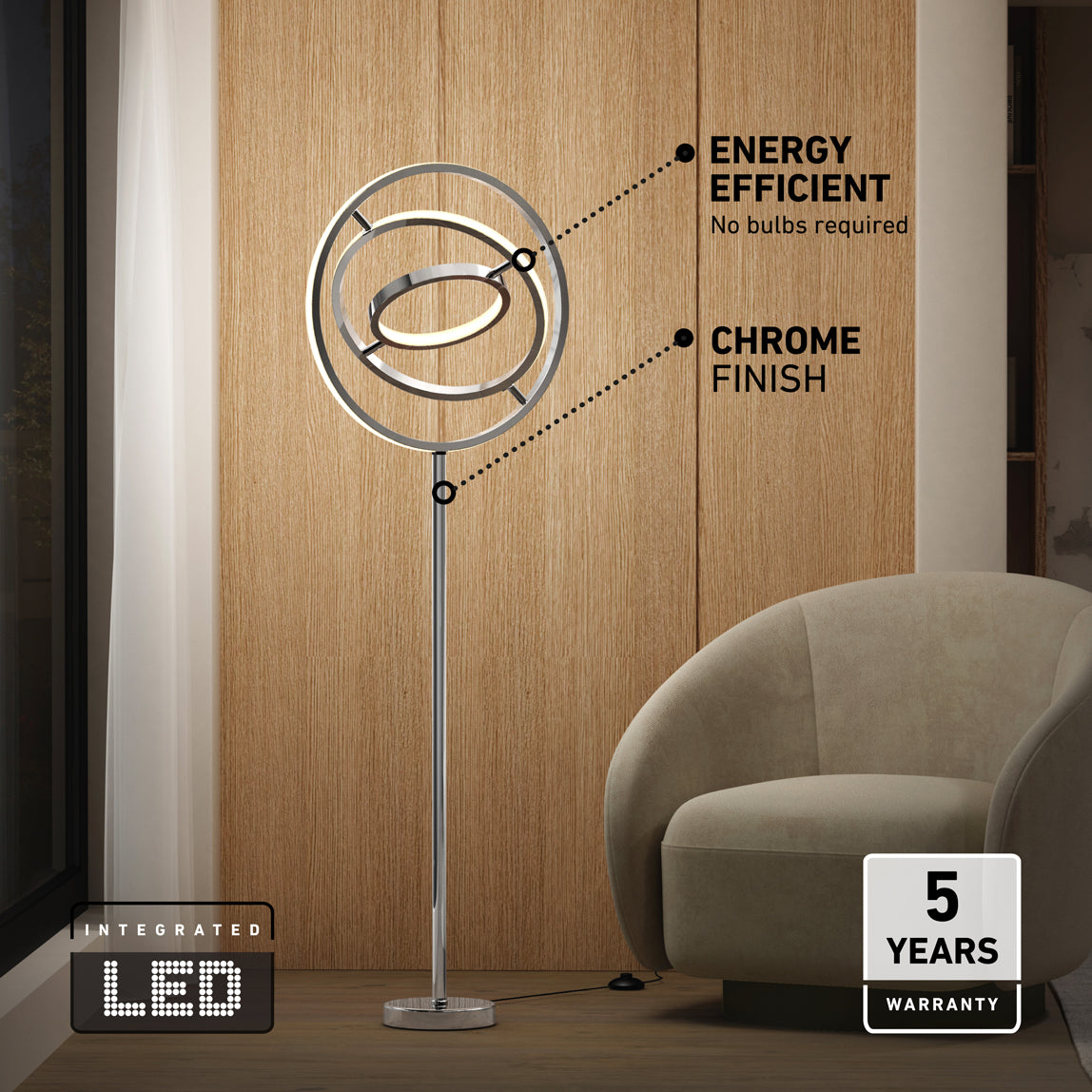 Modern chrome floor lamp with circular, integrated LED design stands by a beige armchair and wooden panel wall. Text highlights energy efficient, chrome finish, and 5 years warranty.