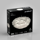 A black box with artika branding displays an image of a white, feather-like LED pendant light called Plume. The box highlights features like adjustable height, 50,000 hours lifespan, and 1000 lumens.
