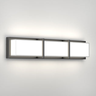 Artika Subway 27-in LED Vanity Light Bar with metallic frame and 3 white panels, mounted on a plain white bathroom wall.