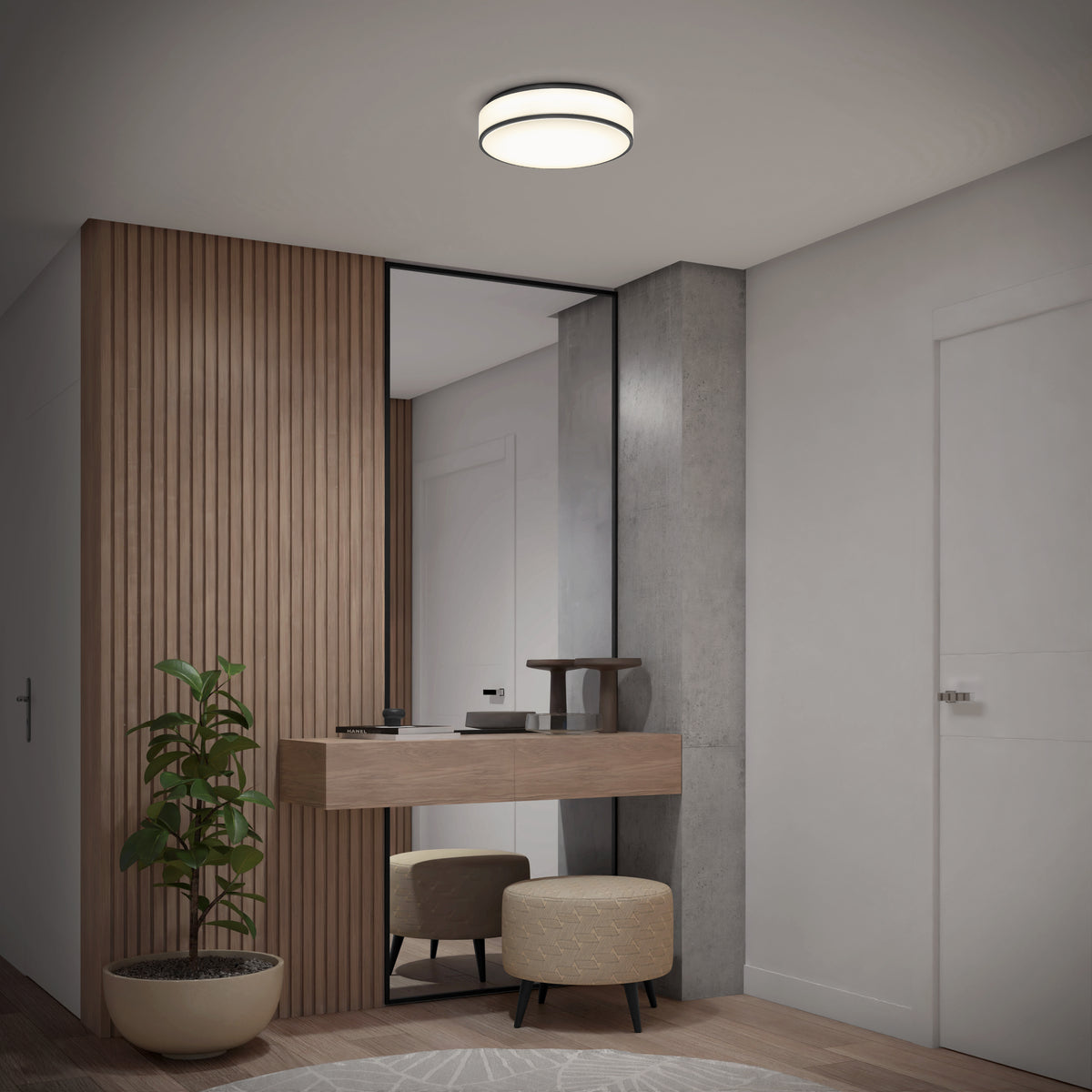 A clean, minimalist entryway features wood paneling, a tall mirror, a floating console, two round ottomans, a potted plant, and is illuminated by the Artika Giada 15 in. LED modern flush mount light with 5 CCT settings.