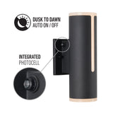 A black cylindrical outdoor wall light with a labeled integrated photocell feature and “Dusk to Dawn Auto On/Off” text, showing automatic lighting functionality controlled by the photocell.