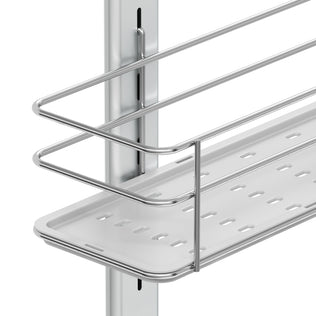 A close-up of the Artika Camden Shower Caddy shows its metal wire shelf with a perforated white tray, mounted on a vertical rail as part of an adjustable storage system.