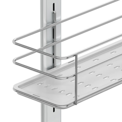 A close-up of the Artika Camden Shower Caddy shows its metal wire shelf with a perforated white tray, mounted on a vertical rail as part of an adjustable storage system.