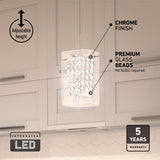 A modern pendant light with chrome finish and premium glass beads hangs in a kitchen; features include adjustable height, integrated LED (no bulbs required), and a 5-year warranty.