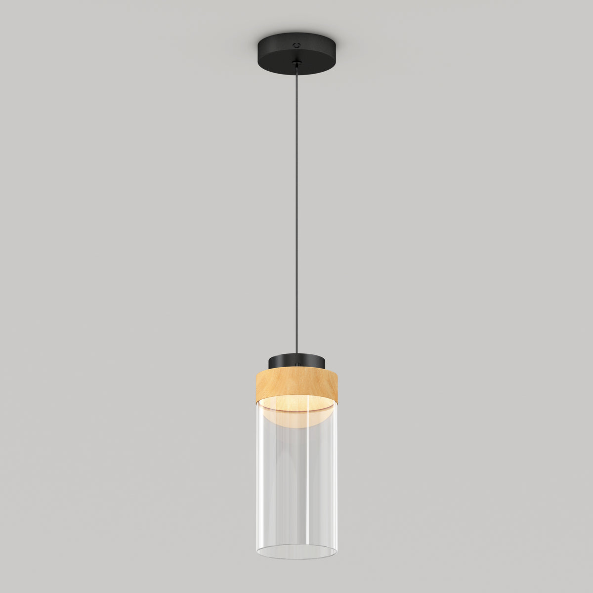 The Artika Hanson 1-light LED pendant 5 CCT features a black ceiling mount, black cord, wooden accent, and clear cylindrical glass shade, shown against a plain light gray background.