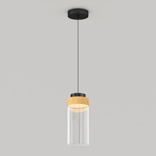The Artika Hanson 1-light LED pendant 5 CCT features a black ceiling mount, black cord, wooden accent, and clear cylindrical glass shade, shown against a plain light gray background.