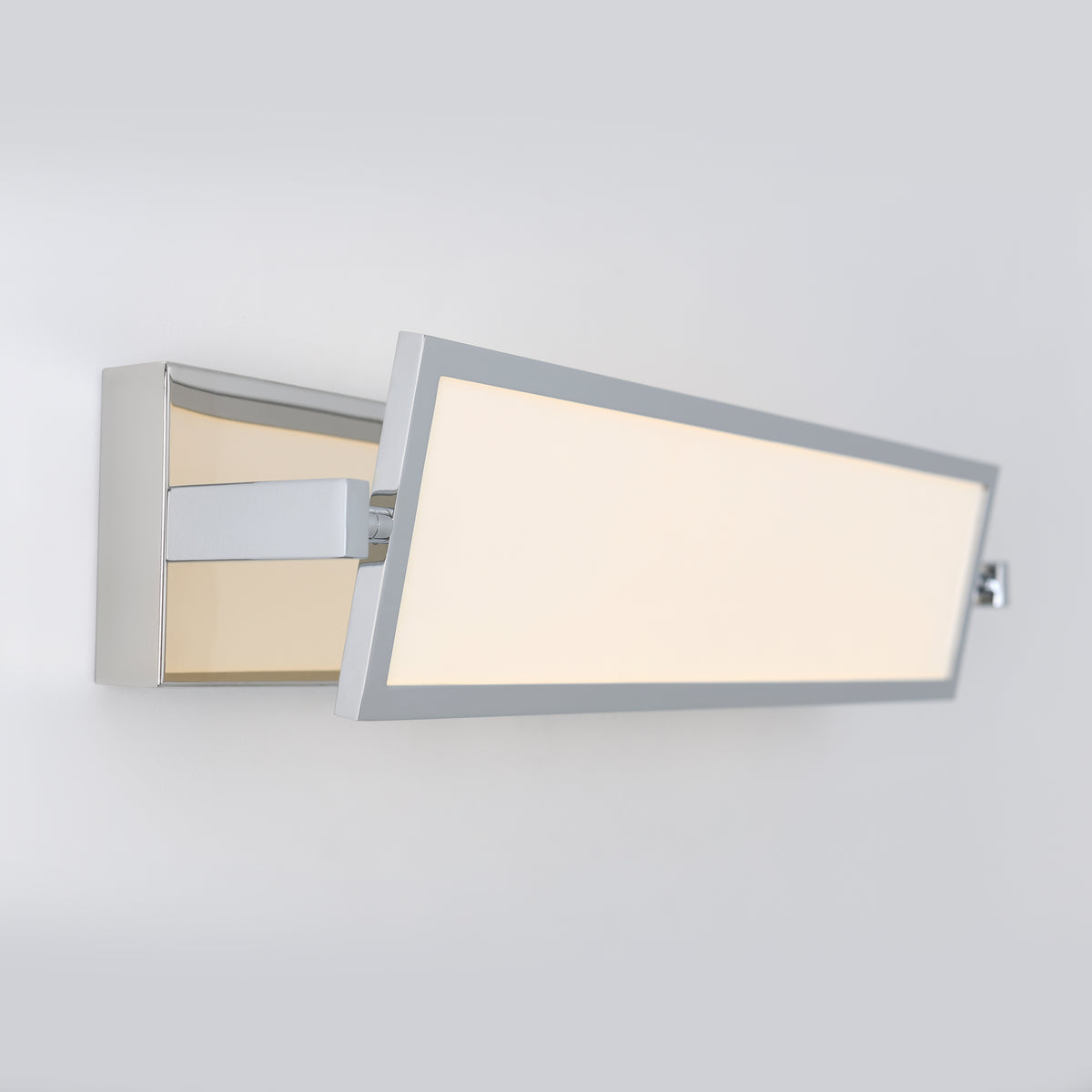 A modern, rectangular wall-mounted LED light with a chrome frame and frosted panel, angled outward from the wall against a plain light gray background.