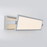 A modern, rectangular wall-mounted LED light with a chrome frame and frosted panel, angled outward from the wall against a plain light gray background.