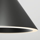 Close-up of a modern, black, conical lampshade with a glowing white inner edge, set against a plain light gray background.