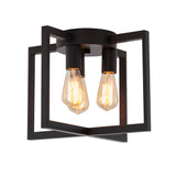 A modern ceiling light fixture with two exposed Edison bulbs and a geometric black metal frame, viewed against a white background.
