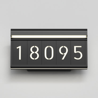 The Artika Bowen modern LED outdoor address wall light displays illuminated white numbers "18095" on five separate panels, mounted on a light gray wall.