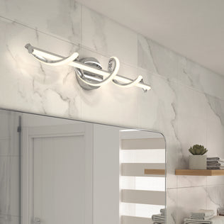 A modern bathroom with a marble wall features the Artika Coda modern LED bathroom vanity light 5 CCT in chrome and white above a large mirror. To the right, there’s a wooden shelf holding a small plant and towels.