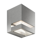 A modern, square, brushed metal wall light fixture with clear glass panels on two sides and a minimalist design.