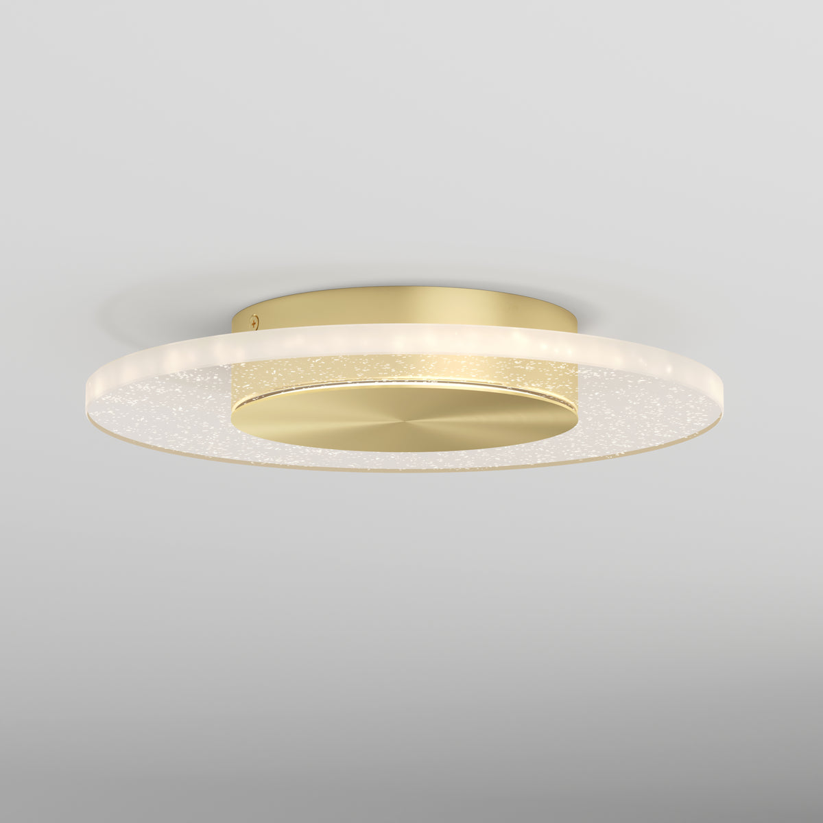The Artika Essence Disk LED flush mount is a modern, round gold ceiling light featuring a flat circular base and a glowing translucent ring, elegantly installed on a white ceiling.