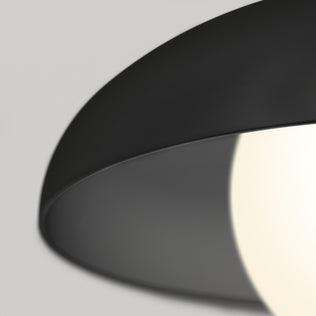 Close-up of the Artika Boden LED modern mid-century pendant light 3 CCT in black, featuring a partially covered glowing white bulb against a soft gray background.
