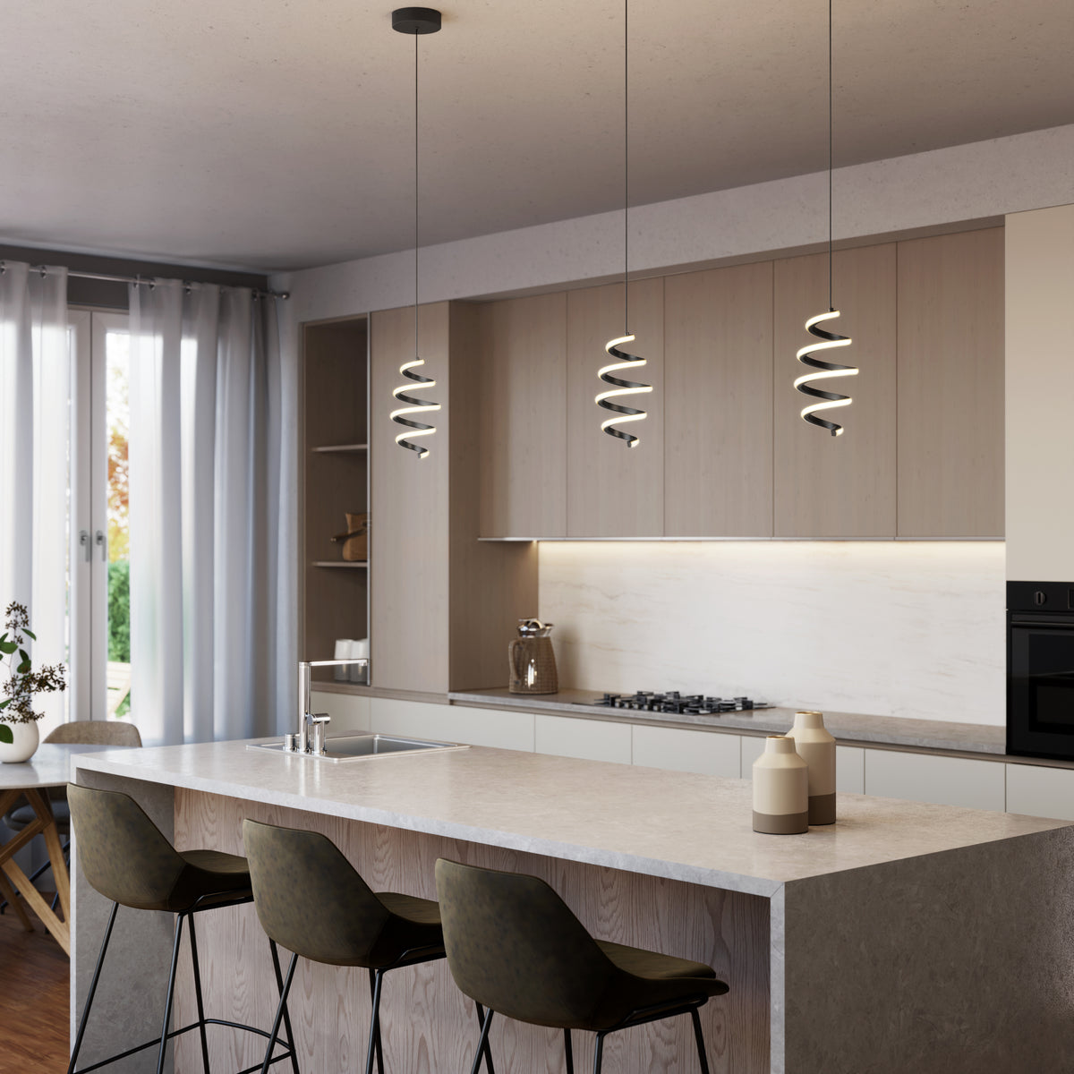 Modern kitchen featuring a light wood island, three dark cushioned bar stools, built-in cabinets, stove, oven, and large windows with sheer white curtains. Decorative lighting provided by Artika Chorus 1-light LED pendant 5 CCT above the island.
