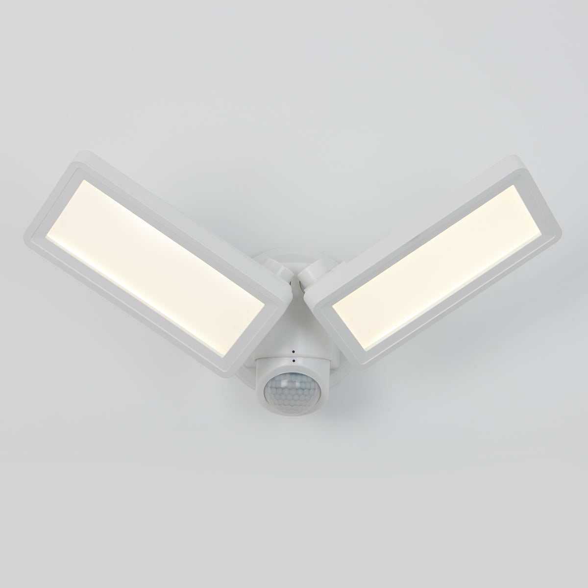 The Artika Sentinel outdoor Flat Panel Security light, featuring two adjustable rectangular white LED panels and a central motion sensor, is shown wall-mounted against a plain white background.