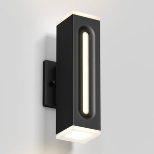 The Artika Linea Square LED indoor-outdoor wall light features a modern black rectangular design with a central vertical LED and illuminated edges, shown mounted on a light-colored wall.