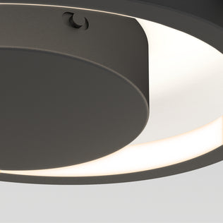Close-up of the Artika Salto LED flush mount light featuring a modern circular design, dark matte finish, and glowing white ring emitting soft light against a plain background.