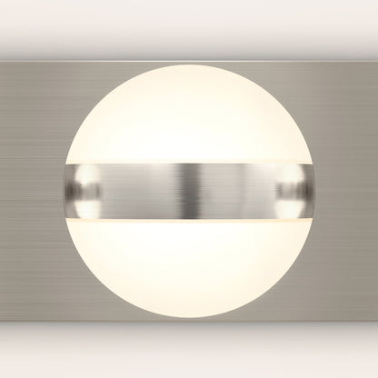 A modern wall sconce with a glowing white spherical light partially covered by a brushed metal horizontal band, mounted on a brushed metal rectangular backplate.