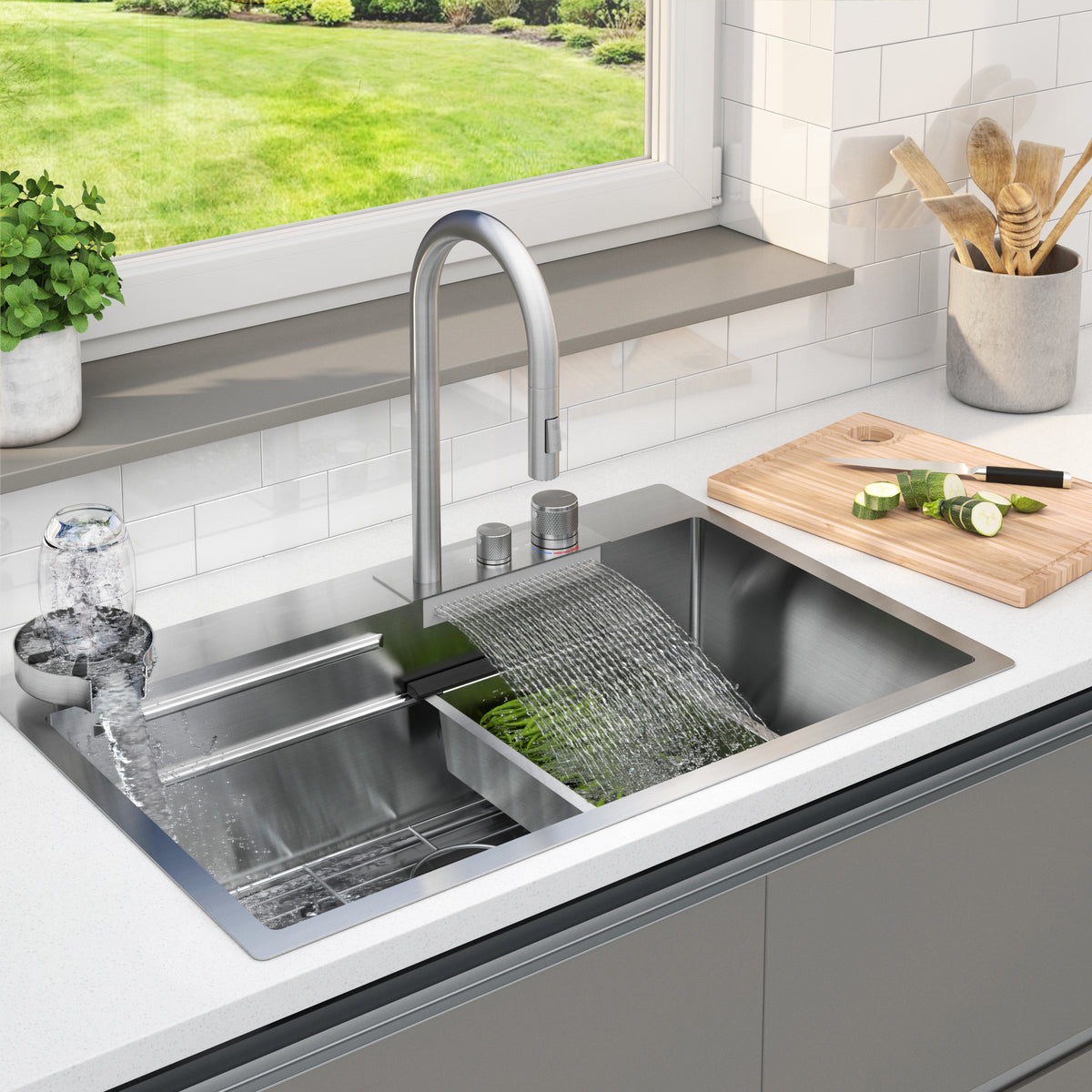 A modern kitchen sink with a faucet running water into two sections: one for rinsing vegetables and another washing a glass. A cutting board with sliced cucumber and a potted plant sit on the counter by a window.
