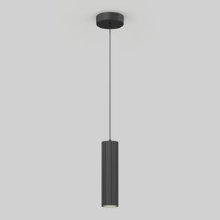 The Artika Groove LED modern pendant light features a black, vertically ribbed cylindrical shade hanging from a thin cord on a round ceiling mount, displayed against a plain light gray background.