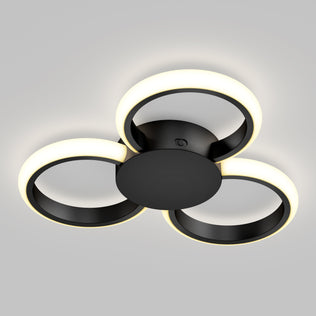 The Artika Nyala 15 in. LED flush mount light features three black circular rings with soft white illumination, arranged in a triangular pattern, making it a modern ceiling fixture for any space.