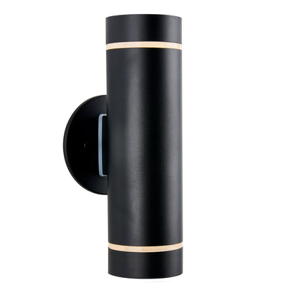 The Artika C7 indoor-outdoor wall light is a modern black matte cylindrical sconce with a circular base and slim horizontal openings at the top and bottom for illuminating spaces.