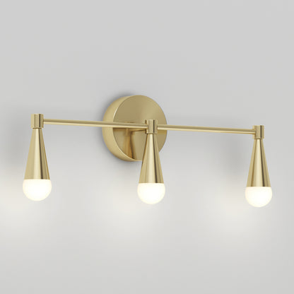 The Artika Wayden LED mid-century bathroom vanity light 3 CCT features a brushed gold finish, three downward cone arms with round frosted bulbs, and a circular backplate mounted on a light gray wall.