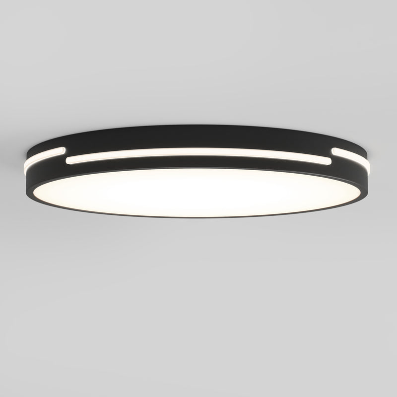 The Artika Delray 15.7 in. LED modern flush mount light features a black outer ring, glowing white center, horizontal edge slits for accent lighting, and is mounted on a plain white ceiling. Offers 5 CCT options for customizable ambiance.