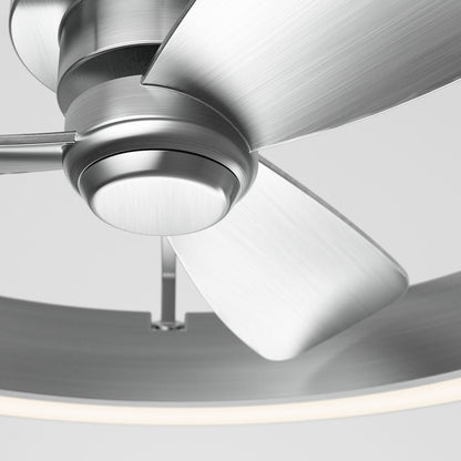 Close-up view of a modern brushed metal ceiling fan with three blades and a circular light ring, set against a plain light background.