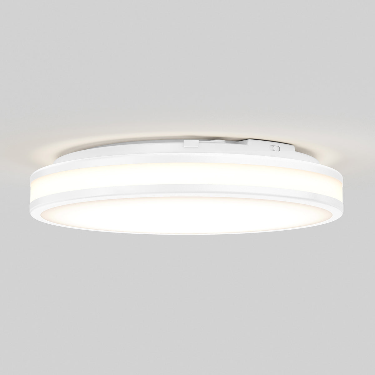Artika Hemisphere 15″ LED flush mount ceiling light features 5 CCT adjustable brightness, glowing softly on a light gray ceiling.