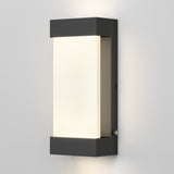 A modern rectangular wall sconce with a black frame and frosted white center panel, mounted on a light gray wall and emitting a soft, even glow.