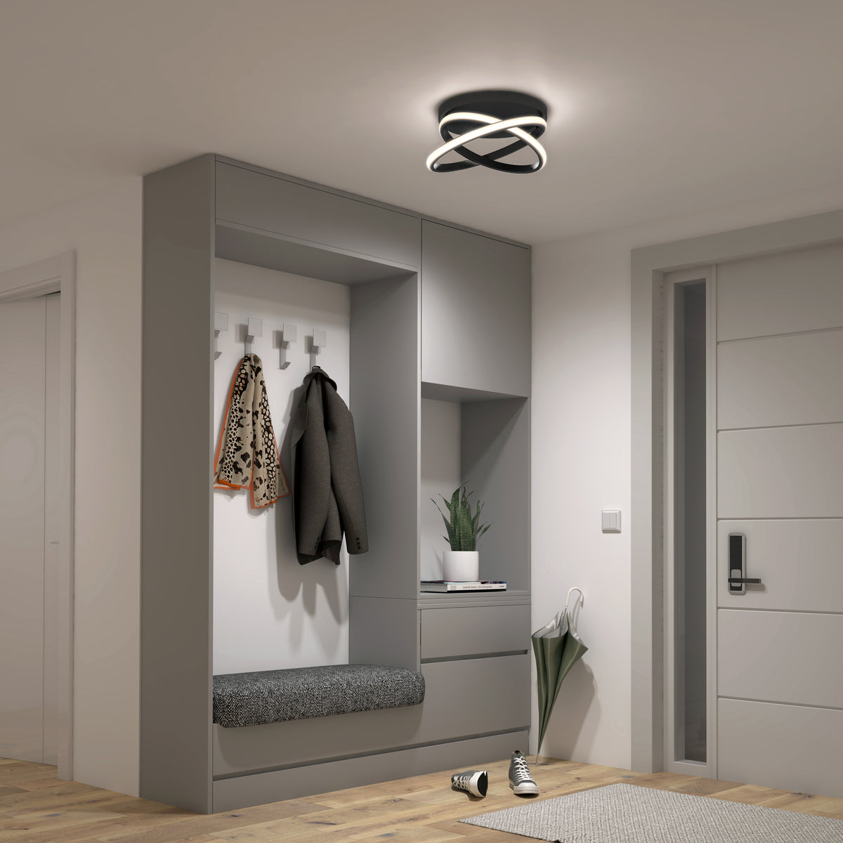 A modern entryway featuring built-in gray cabinets, a cushioned bench, coat hooks holding a jacket and scarf, a decorative plant, and an Artika Orbia modern LED flush mount light 3 CCT on the ceiling.