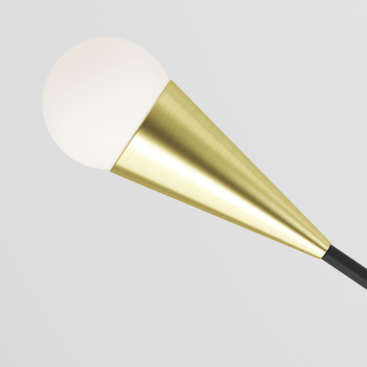 A modern wall lamp with a frosted white globe light and a gold metallic cone-shaped fixture against a plain light gray background.