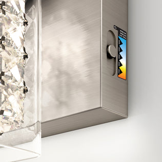 A close-up of the Artika Crystal Cube LED bathroom vanity light 5 CCT, featuring a textured glass element on the left and a color temperature adjustment dial with a warm-to-cool gradient label on the right.