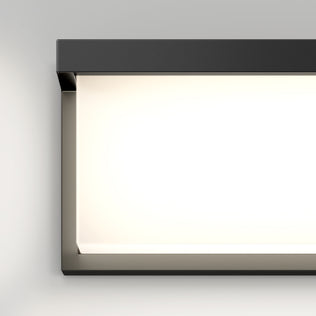 The Artika Bristol modern LED bathroom vanity light (3 CCT) features a black frame, glowing softly against a light gray wall.