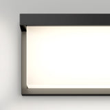 A modern rectangular wall light fixture with a black frame and a bright, glowing white panel, mounted on a light gray wall.