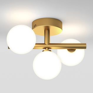 The Artika Bloom modern mid-century LED flush mount light 5 CCT features a gold finish with three asymmetrical frosted glass globes on a short bar, attached to a circular base, casting a soft ceiling glow.