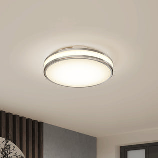 The Artika Hemisphere 15 in. LED Flush Mount Ceiling Light with 5 CCT is lit on a beige ceiling in a modern room.