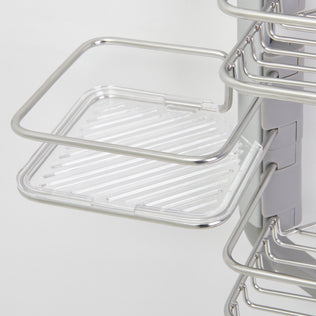 Close-up of the Artika O2 hanging Shower Caddy, a metal wire rack with a clear plastic tray featuring diagonal stripes. Multiple adjustable shelves are attached to its vertical support.