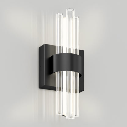 The Dorado LED contemporary wall sconce by Artika features a black rectangular base, curved band, and vertical clear glass rods that diffuse light, shown mounted on a light gray wall.