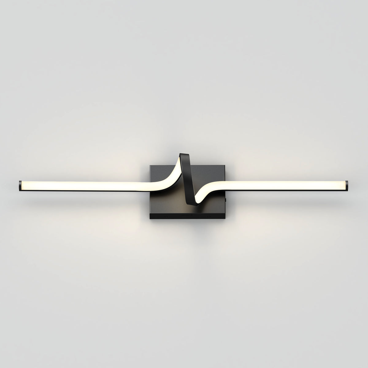 A modern wall light fixture with a horizontal, wavy LED bar mounted on a square black base, casting soft illumination on a plain white wall.