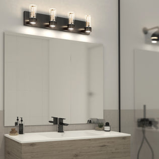Modern bathroom vanity with an Artika Essence 27-in LED light, large mirror, sink, soap dispensers, and decorative plants on the counter.